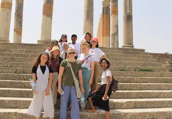 group of college students in front of Meknes Landmark