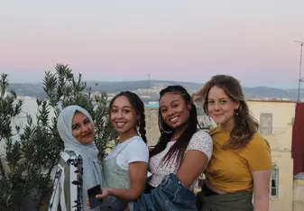 4 college female students with backdrop of tangier