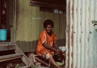 My Grandma cutting coconuts.