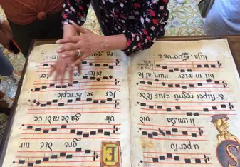 being able to touch a centuries-old song book made of sheep's skin at the Monastery in Catania.