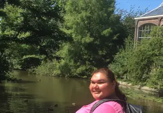 A photo of myself sitting on a bridge next to a canal near the Hortus Garden