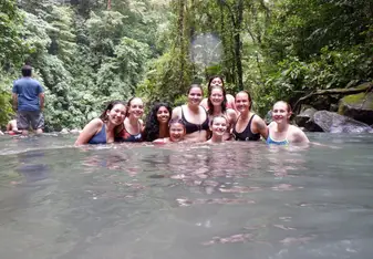 A portion of our group cooling off in the waterfall after surviving the descent of +500 steps, and preparing to make the trek back up to the top. 