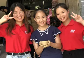 My teaching assistants and a student at pottery making!