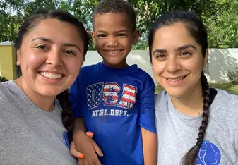 My friend and I with one of the kiddos at camp