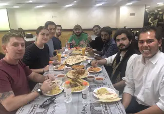 Fellow students enjoying delicious Yemeni food. Sorry y'all, but eating utensils aren't allowed here.