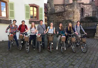 A group of students biking through Colmar on a weekend getaway.