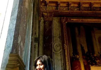 Me looking at paintings in the Palace of Versailles