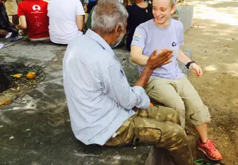 Volunteering at the Relief settlement and playing hand games with one of the men there