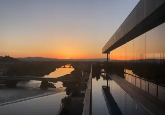 Sunset over the Arno River in Florence from a rooftop bar