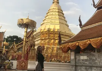 Me standing in front of a beautiful gold Buddhist temple. 