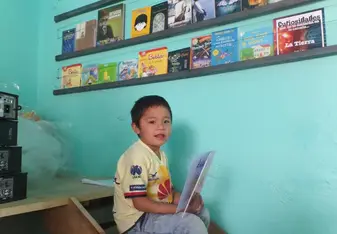 Manuel reading in the library
