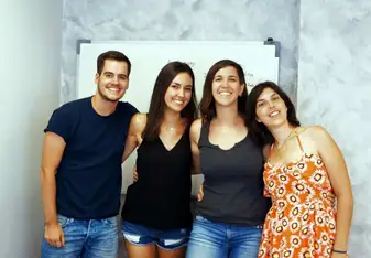 Four people smiling.