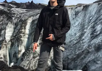 Pointing at the spikes that were tied to my feet during the Glacier Hike.