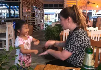 playing with a new friend at a restaurant