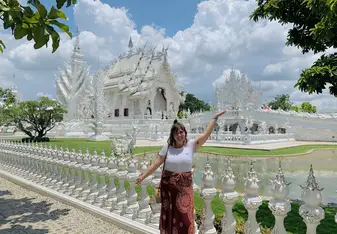 Posing in front of The White Temple, a famous architectural temple in Chaing Rai, Thailand