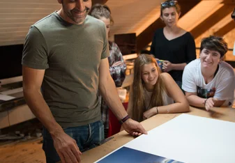 Male teacher showing Cowhouse gap year students prints