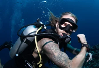 Scuba diver flexing his muscles underwater