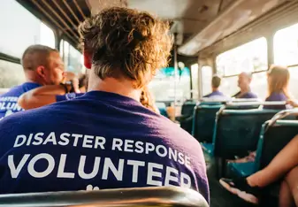 Responsible male volunteer on a bus. 