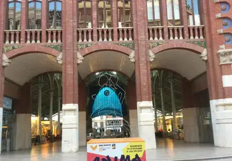 The Colon Market in Valencia, a masterpiece and a market place, with the poster in front motivating supporters to go and cheers up for the runners in the upcoming half marathon of Valencia in the end of October 2019