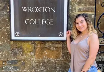 Me outside the abbey gates in front of the college sign