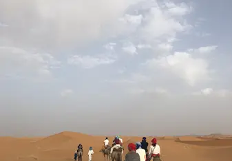 Riding camels through the Sahara desert to where we would camp for the night