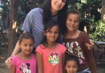 Woman smiles with children in Honduras.
