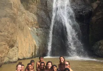 A beautiful hike lead us to a waterfall where some locals were cliff flipping into shallow waters. They got into our photo before finishing some jumps.
