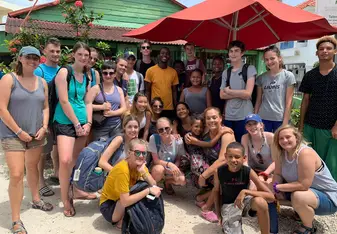 This is a group shot after eating our lionfish meal made by Leny and aided by us!! We also made bags, necklaces, and bracelet for Leny and her family to sell!!