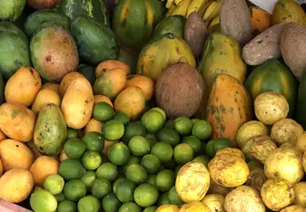A smoothie stand in a town center with an array of fresh fruit. 