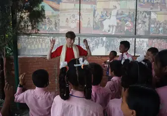 Performing the chicken dance with the children