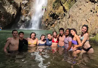My group and I in front of a waterfall after a long hike.