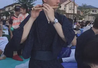 A picture of me in yukata playing a Japanese flute - shinobue.