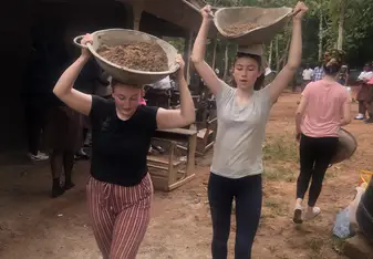 This is an image of two of us working. We were given head scarves by the locals to help us carry our materials for building.