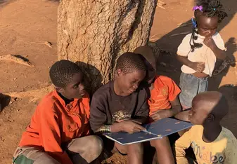 Reading together under a tree