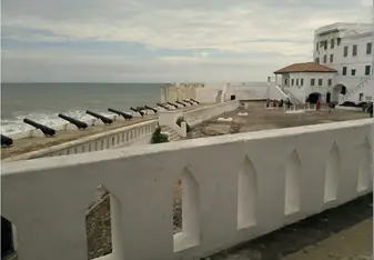 Looking back at the cape coast slave castle and out to sea. Untold numbers of slaves passed through or died in the dungeons below the brick yard.  