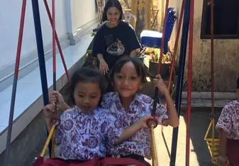 Pushing the children on the swing during their break time - it became like a mandatory activity!