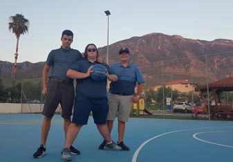 My friends and I playing basketball in Greece with a wonderful backdrop.