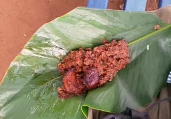 This delicious breakfast of black-eyed peas, rice, and deep-fried pieces of ripe plantain is a common breakfast and easy to get as street food. Here, it has been wrapped in a large waxy leaf for easy eating on the go. 