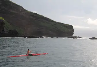 Paddling an outrigger canoe off the coast of Nuku Hiva, Marquesas Islands