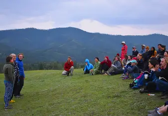 Mongolia Field School 2019 participants gather by the Eg River Science Camp as the course leader briefs them
