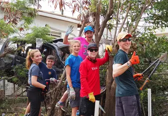 students working to clear vegetation
