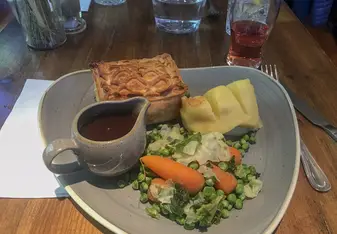dinner of pie and mash with some vegetables