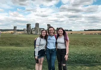 me and two friends outside of Stonehenge