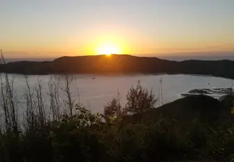 The sun rising over a small bay taken from a hill above Somosomo.