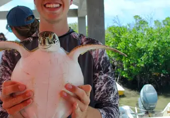 This is me when we were researching sea turtles one day. we actually got to catch them and tag them.