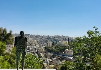 Looking over Amman with a small metal statue in the foreground.
