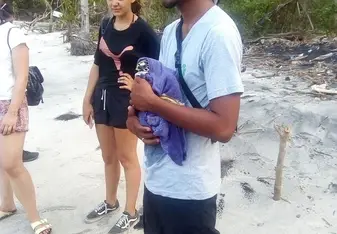 Course Coordinator holding turtle