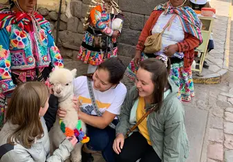 My friends and I fawning over an adorable baby alpaca in the Cusco Plaza de Armas!