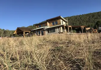 The outside of the HDC's main building, which includes a common room, a kitchen, and an upstairs room where 5 participants may sleep