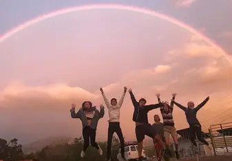 My advisee group jumping for joy beneath a rainbow